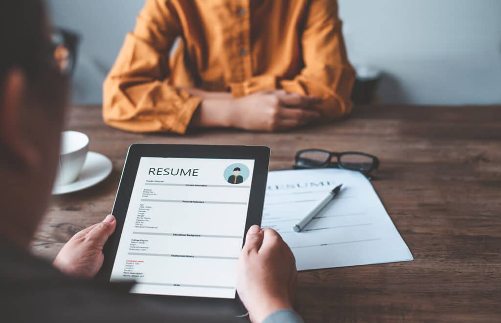 HR managers are interviewing job applicants who fill out their resume on the job application